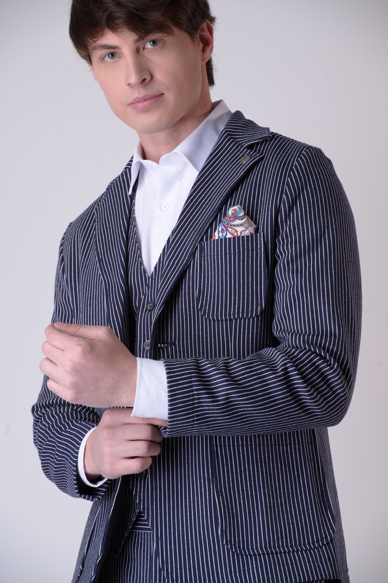 Single-breasted blue pinstripe tailored jacket with V2 fabric interior and pocket square