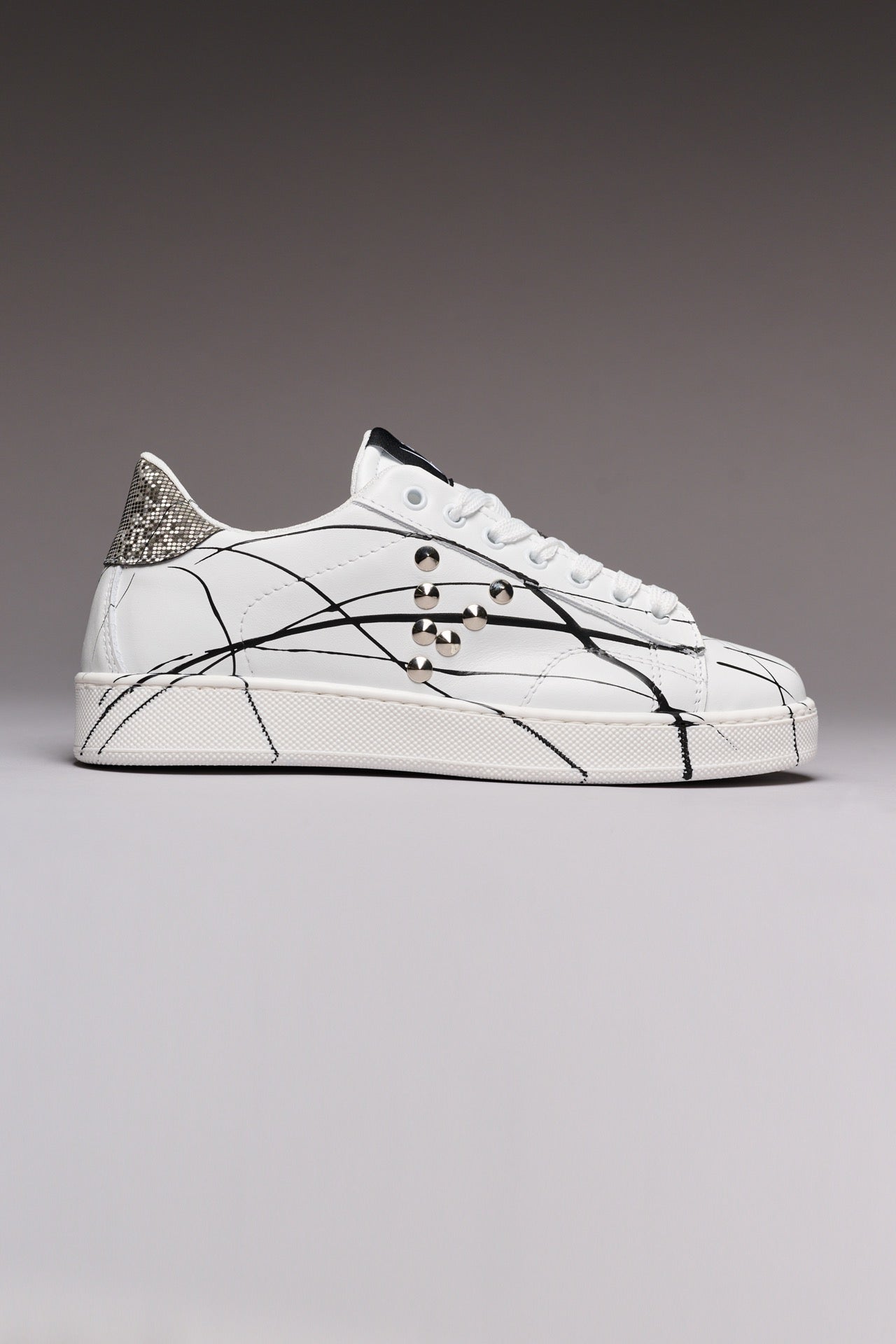 SIERRA - White Low-Top Sneakers with Silver Pixel Back Studs and Paint Splatter