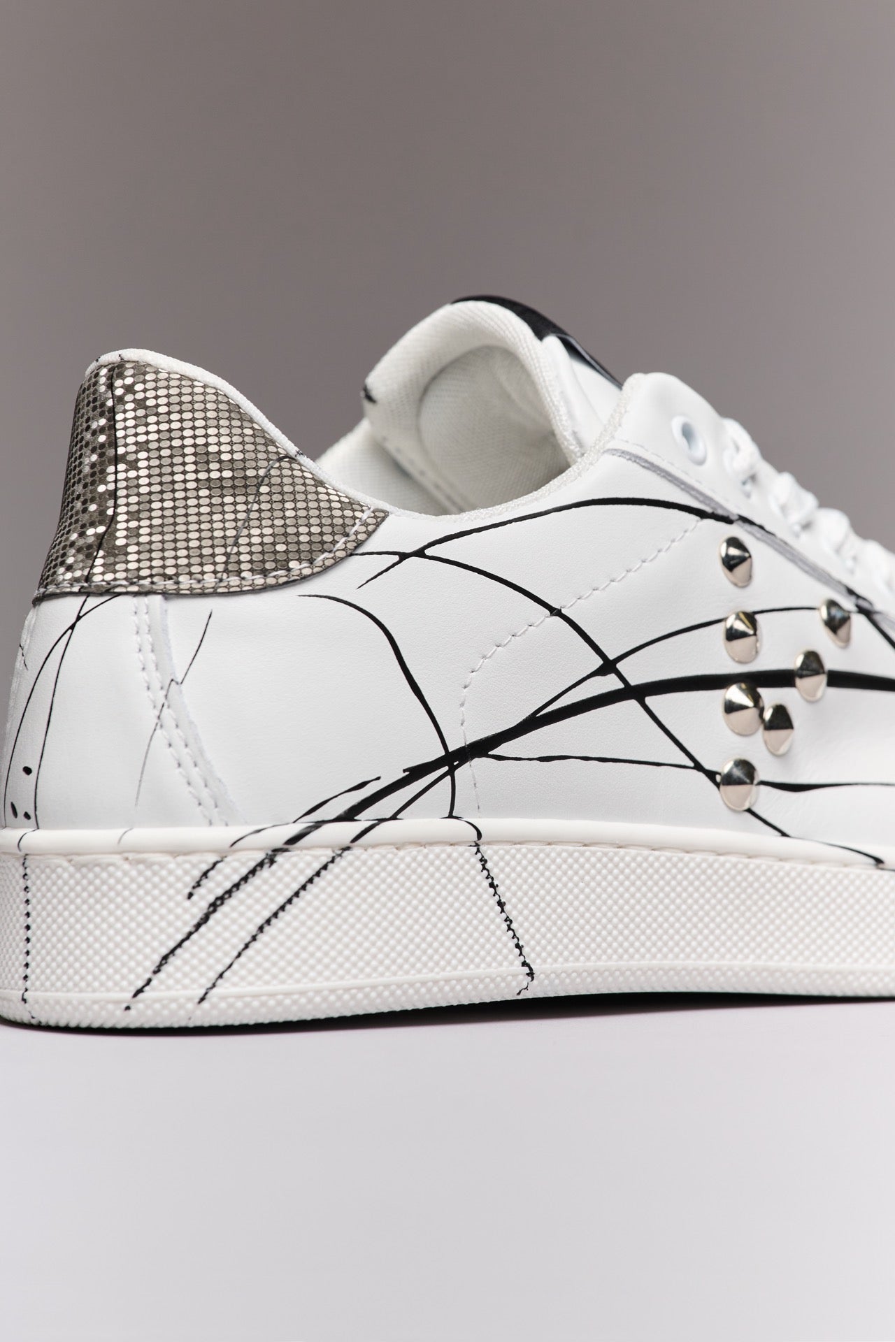 SIERRA - White Low-Top Sneakers with Silver Pixel Back Studs and Paint Splatter