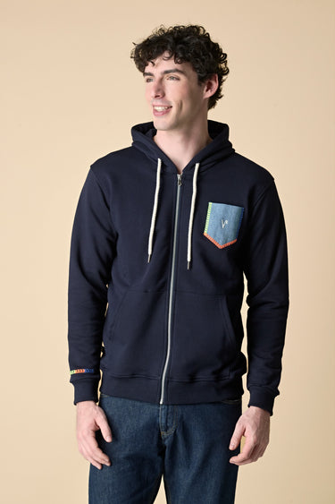 Blue zip-up hoodie with denim pocket and fluorescent embroidery