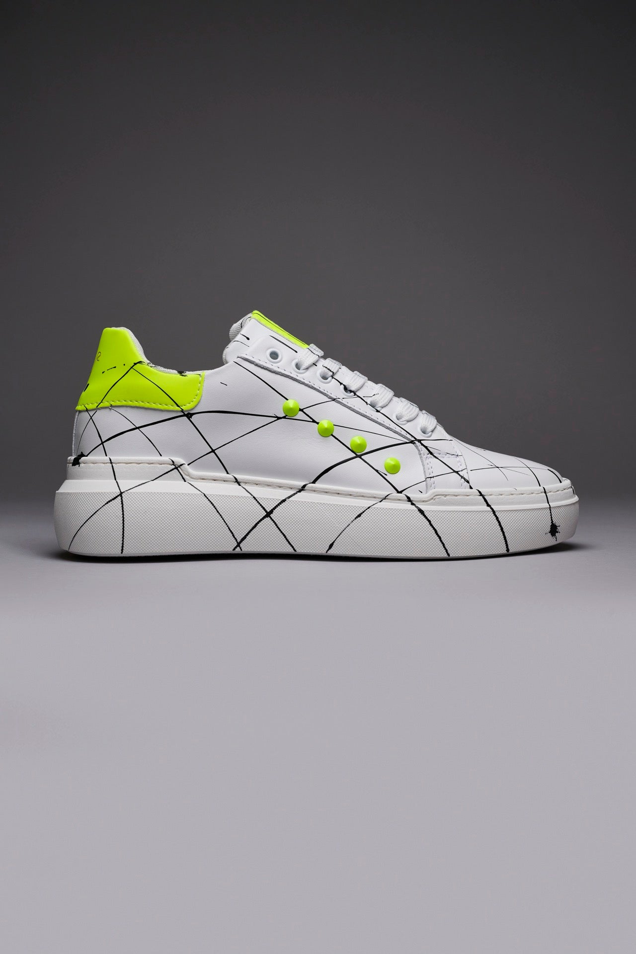 VEGA - Sneakers with high back sole and yellow fluo studs with splashes of paint