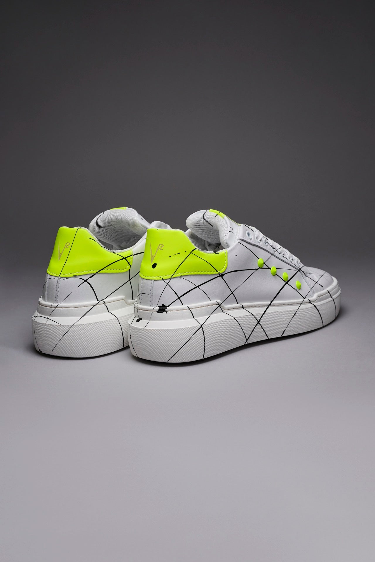 VEGA - Sneakers with high back sole and yellow fluo studs with splashes of paint