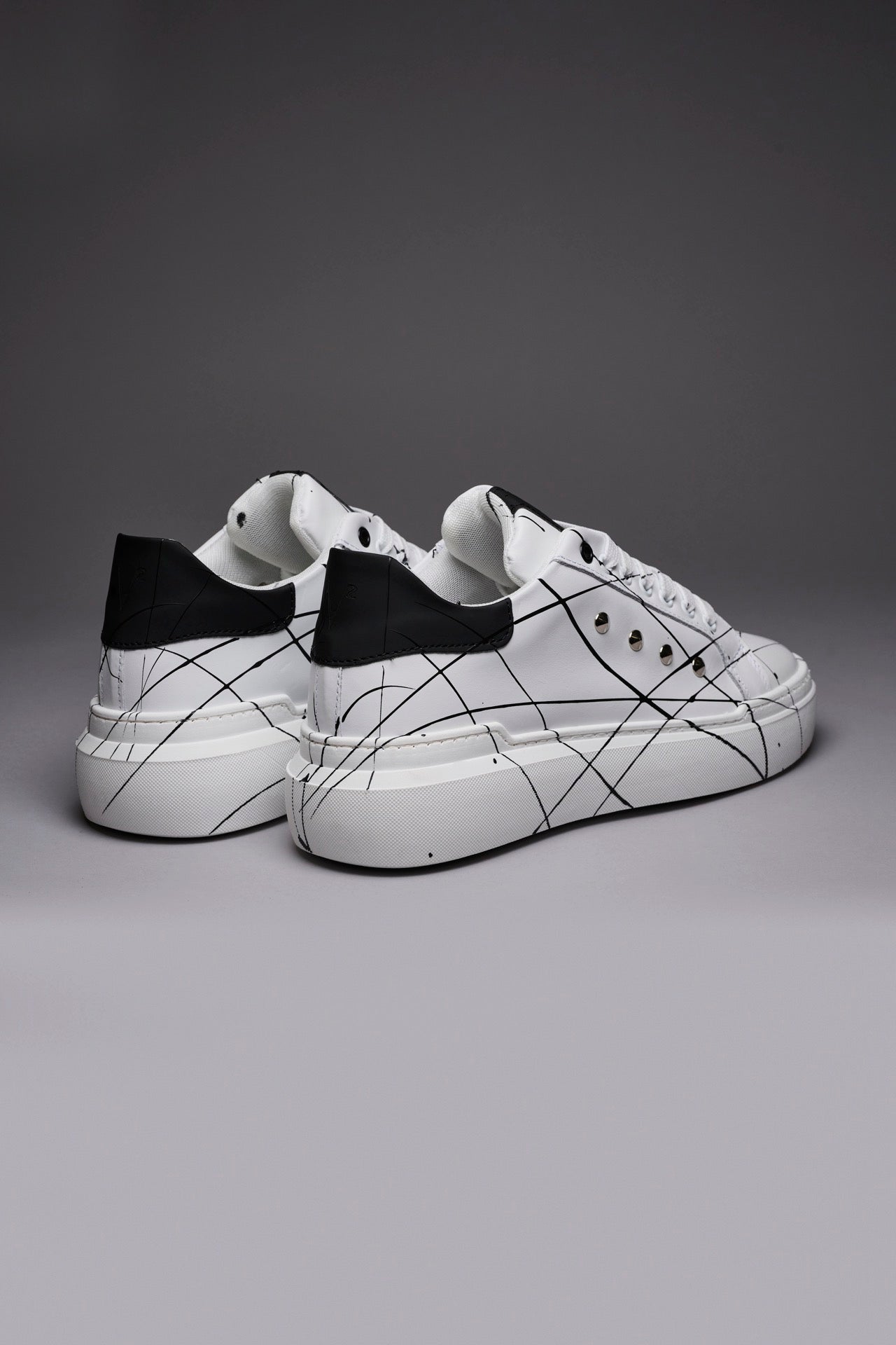 VEGA - Black back high sole sneakers with studs and paint splatters
