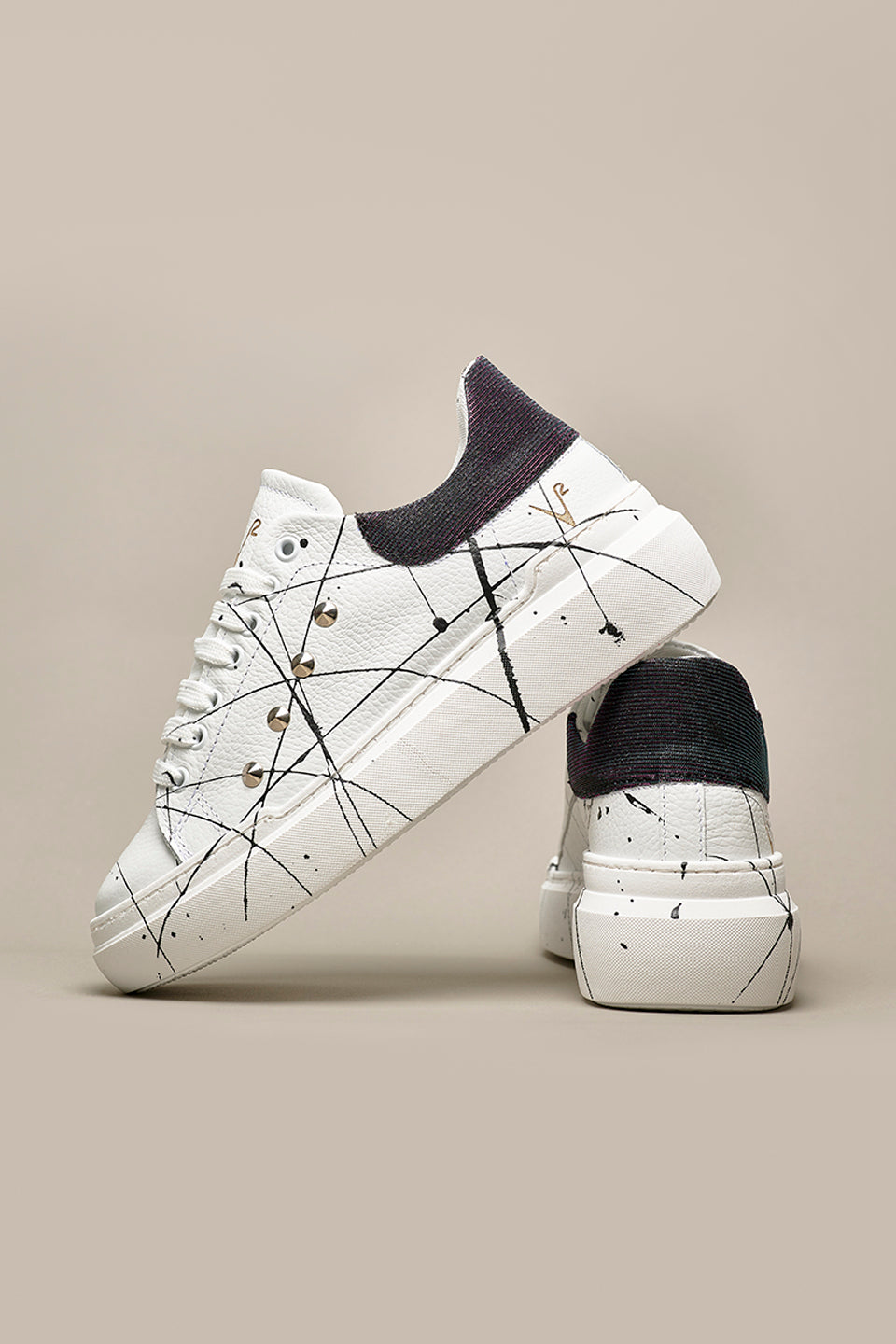 HAMMER - High sole sneakers in White textured leather with Iridescent Black back with studs and paint splashes