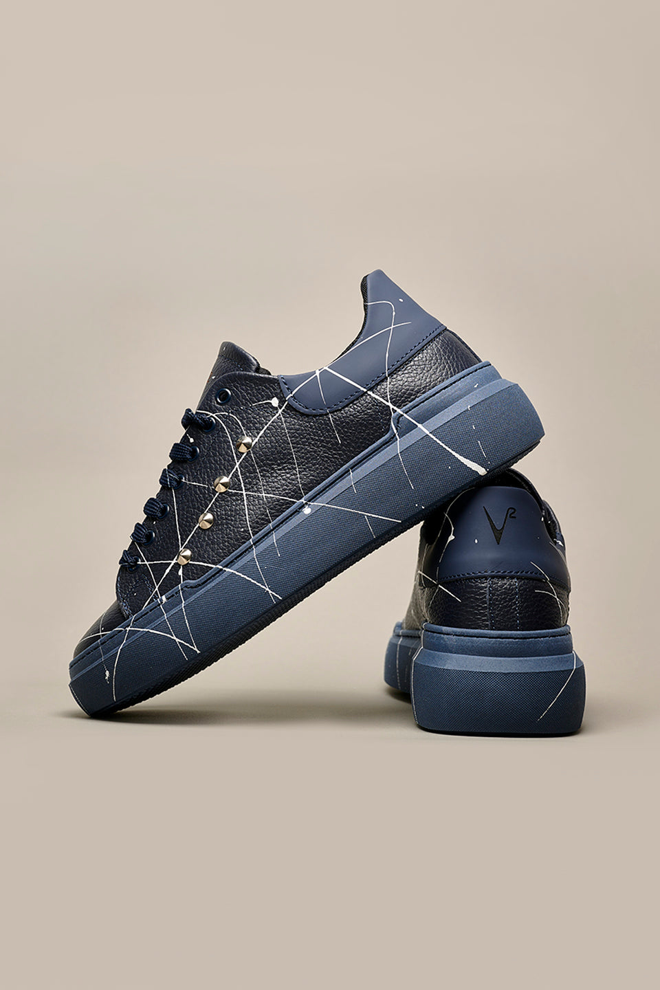 HAMMER - High sole sneakers in blue hammered leather with studs and paint splashes